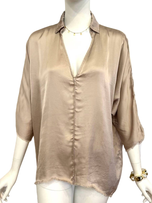 Beige blouse on a mannequin against a white background