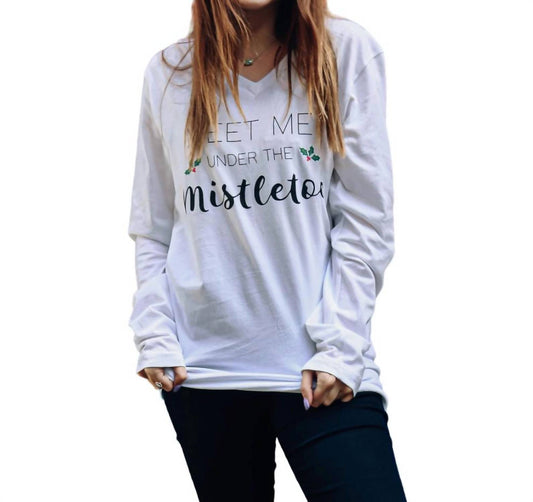 White long-sleeve shirt with text 'Let me be under the mistletoe' worn by a person on a white background